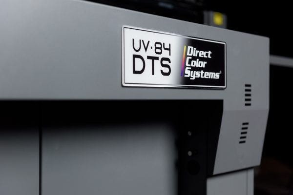 Front panel of a Direct Color Systems UV-84DTS UV-LED flatbed printer showing the UV-84 DTS badge